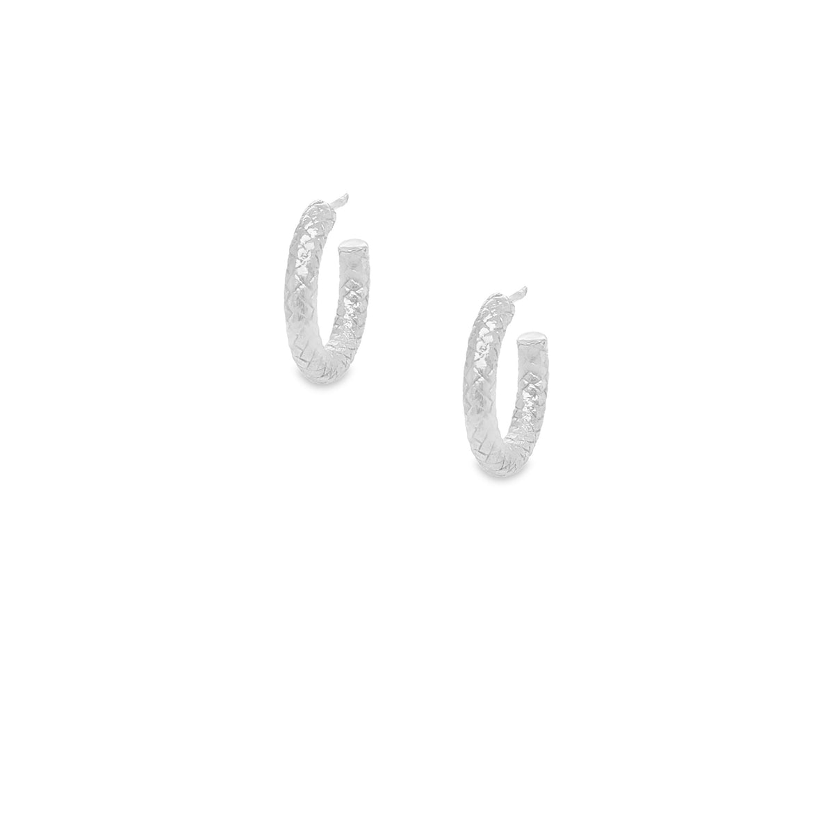 Pair of silver textured hoop earrings on a white background