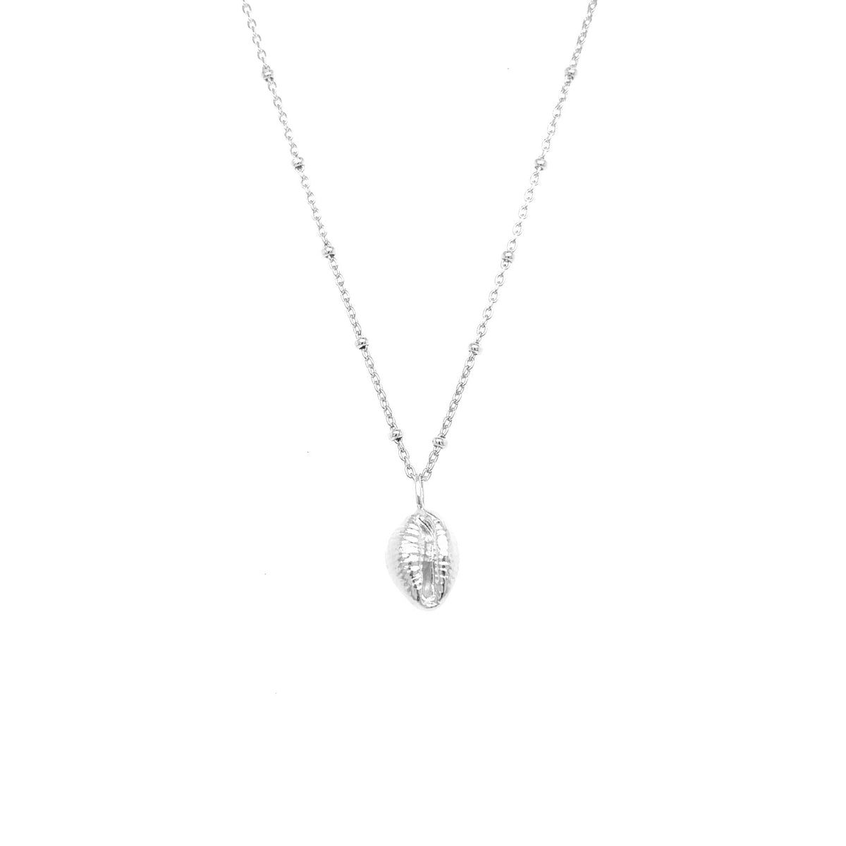 A silver beaded chain necklace with a small, vertically oriented cowrie shell pendant, shown on a plain white background.
