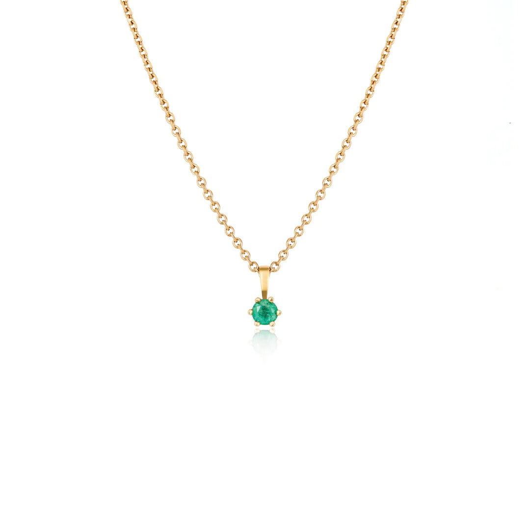 Emerald and fern necklace set featuring a delicate gold chain with a stunning emerald pendant.