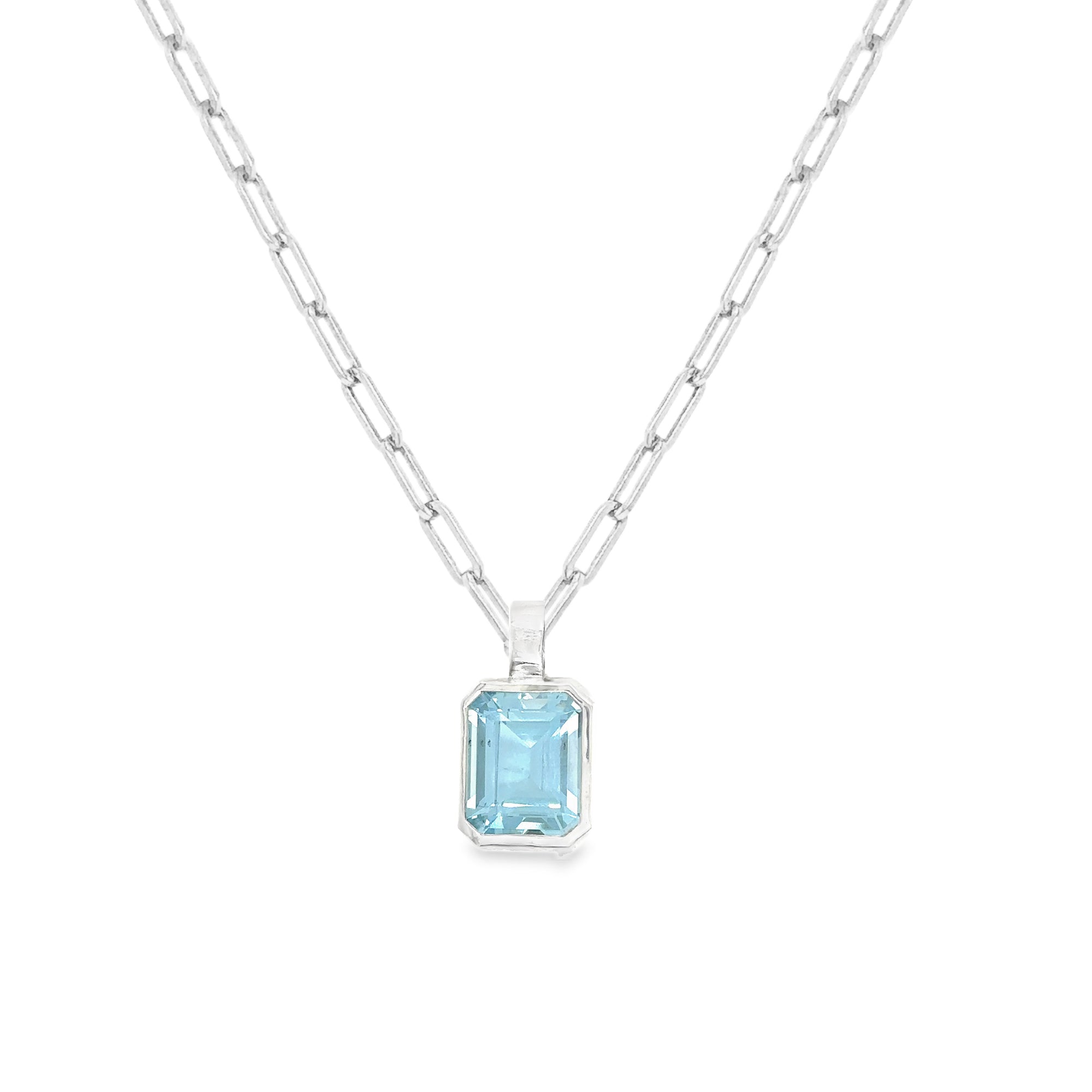 Emerald cut aquamarine pendant on a sleek silver paperclip chain, showcasing a sparkling aquamarine gemstone.