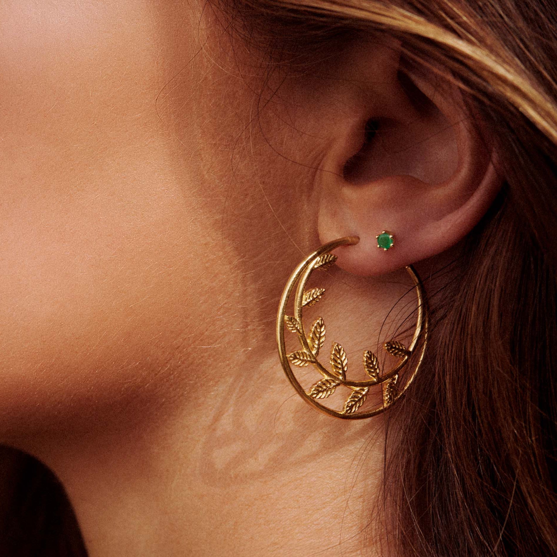 Model wearing Gold Savannah Rosa Hoop Earrings showcasing a delicate botanical design in 18ct gold plated silver.