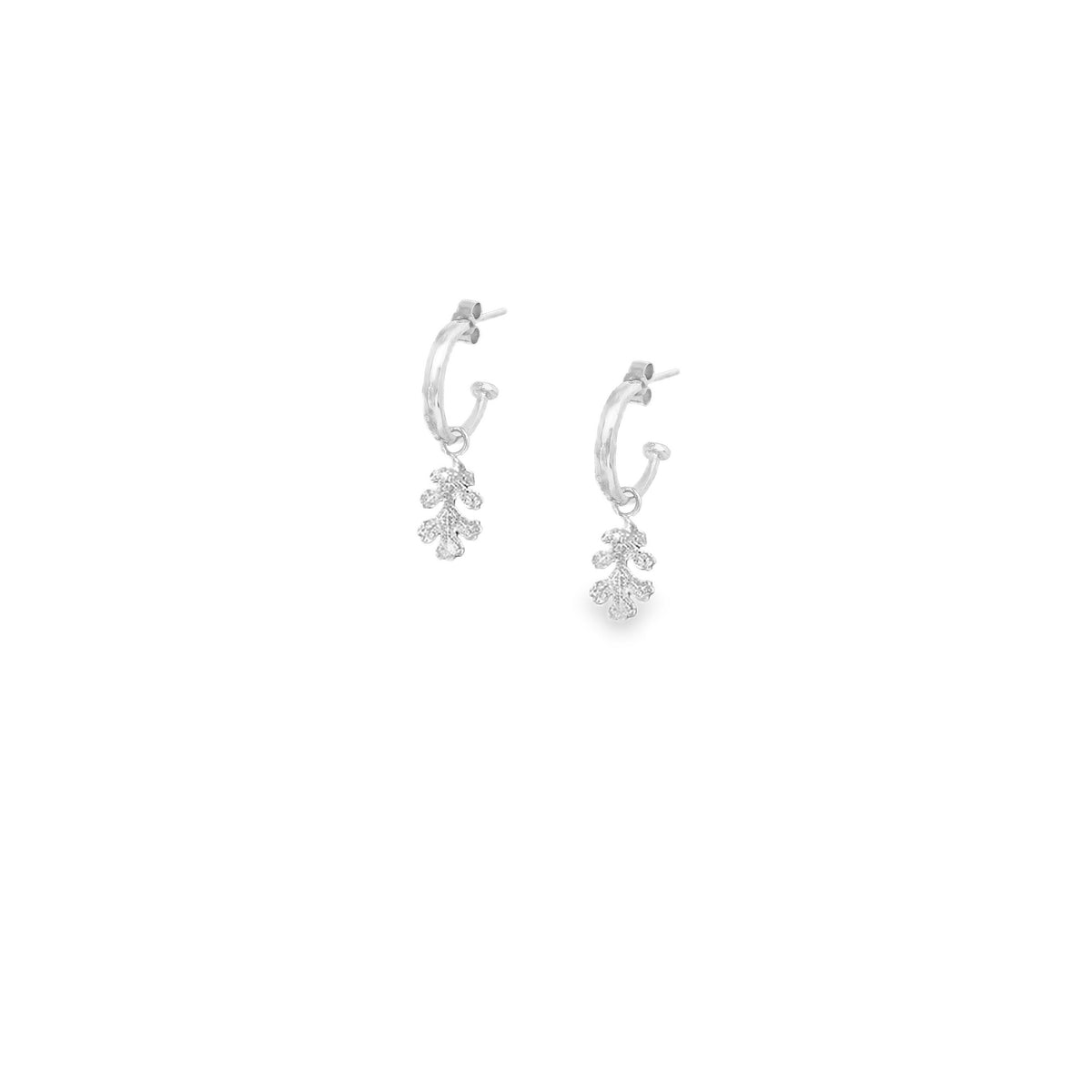 silver hammered hoop earrings with a small oak leaf charm dangling