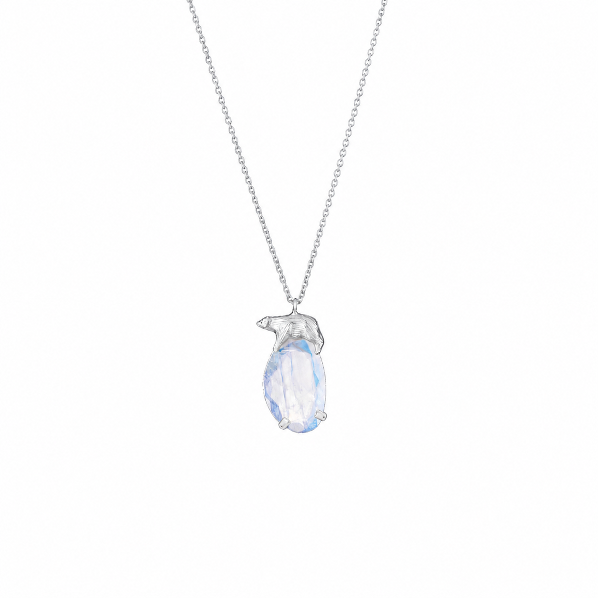 A silver-toned necklace featuring a polar bear sitting on a faceted, iridescent light blue moonstone, shown against a plain white background.