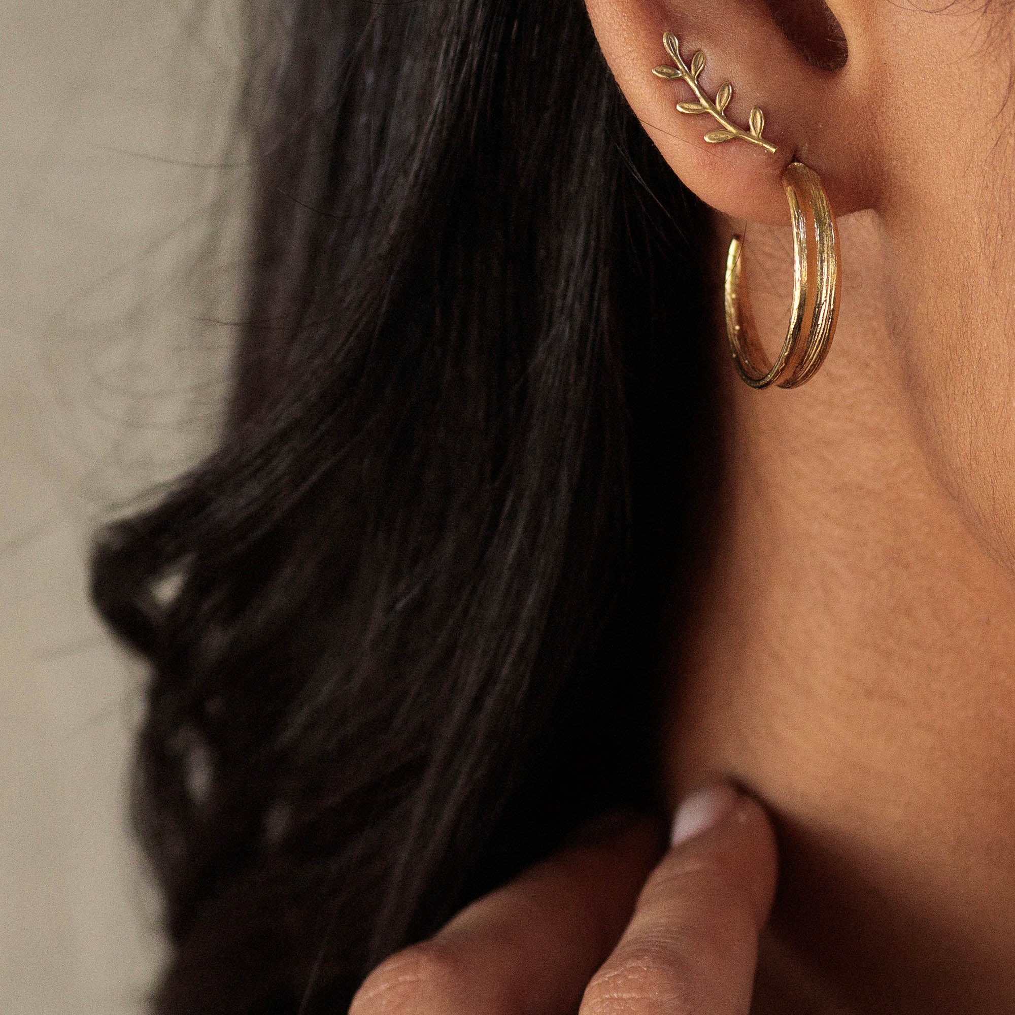 18ct gold plated blade of grass hoop earrings worn on ear 