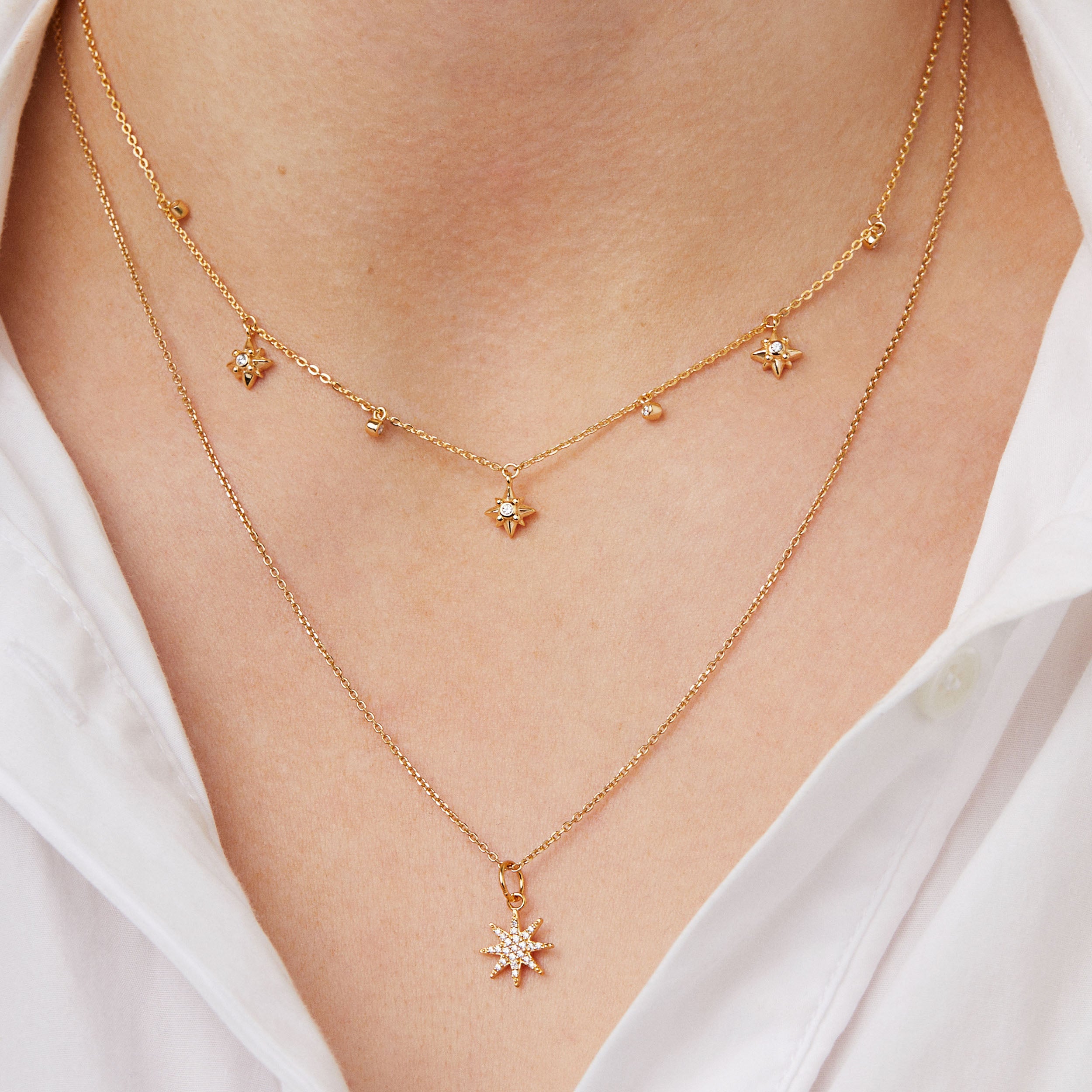 18ct gold plated silver and cibic zirconia star charm pendant on chain necklace stacked on woman 
