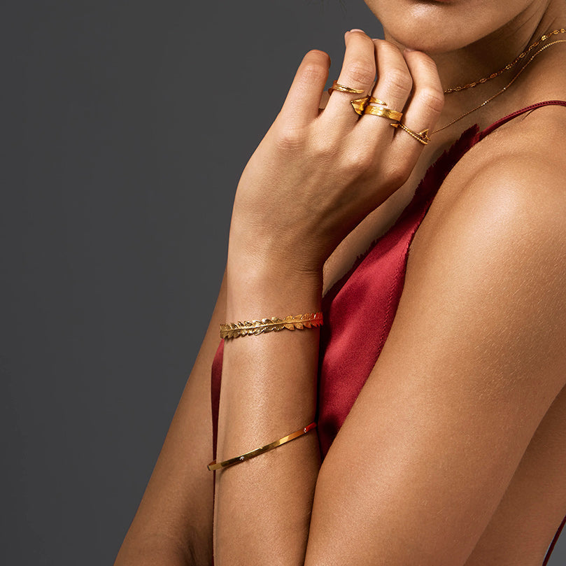 Gold Fern Leaf Cuff - Small worn by model showcasing elegant layerd jewelry style and beauty.