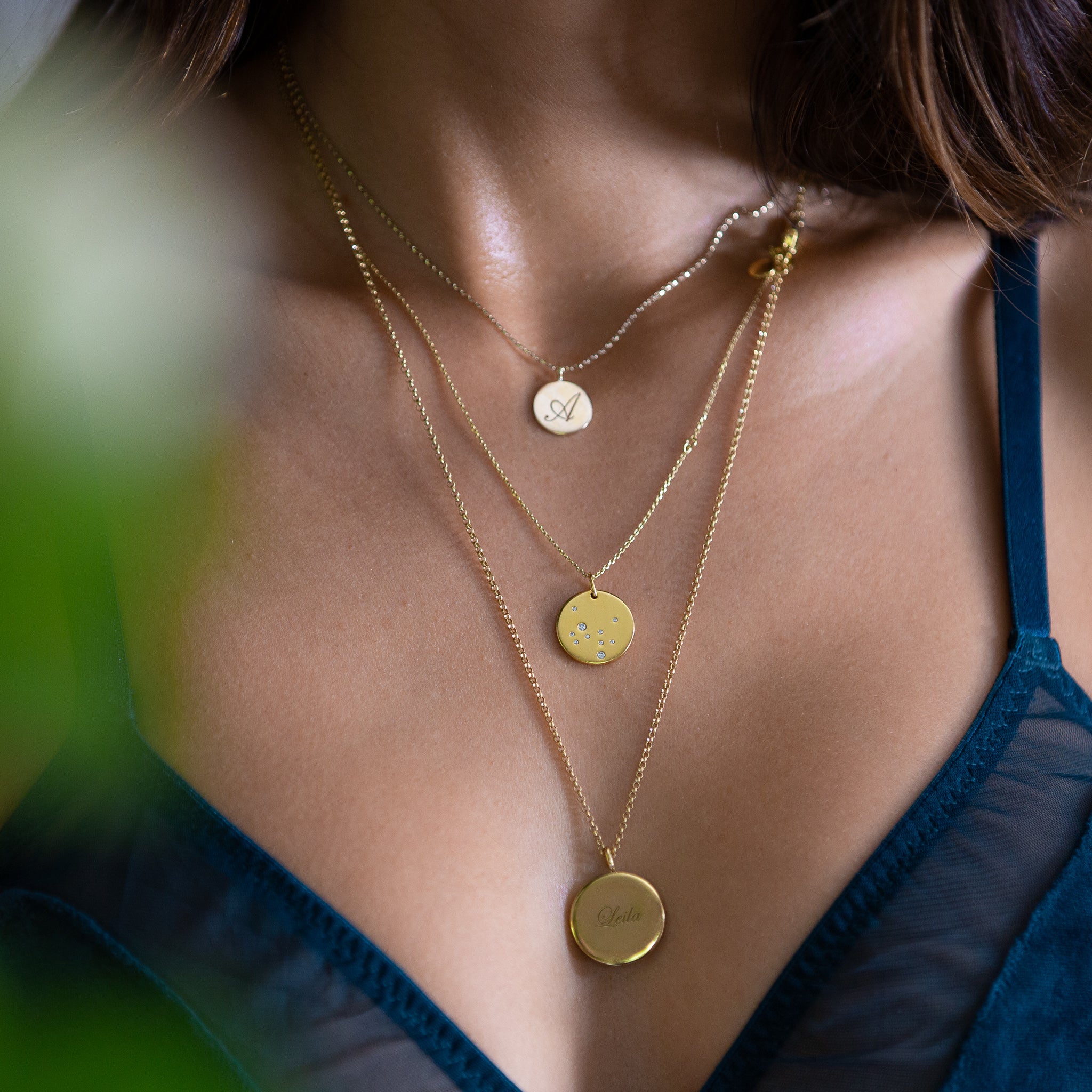 Silver Personalised Initial Pendant worn as part of layered necklace display on a model.